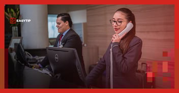 Hotel receptionist answering the phone with easytip logo top left