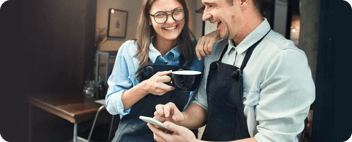Happy coffee shop employees on phone